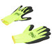 A pair of yellow and black Cordova warehouse gloves with black foam latex palms on a white background.