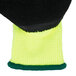 A pair of yellow and black Cordova Cold Snap gloves with green trim.