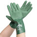 A pair of hands wearing green Cordova dishwashing gloves with a green palm and wrist.