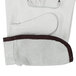 A pair of white Cordova leather gloves with brown trim.