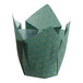 A green paper cupcake wrapper with a gold star pattern.