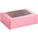 A pink Baker's Mark cake box with a clear window.
