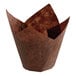 A brown paper tulip baking cup with a brown surface.