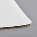 A white corrugated cardboard Baker's Mark quarter sheet cake pad.
