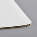 A close up of a white Baker's Mark corrugated cake pad.