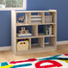 A white wooden Flash Furniture open storage unit with toys on the shelves.