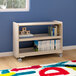 A Flash Furniture wooden mobile storage cart with books and toys on the shelves.