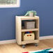 A Flash Furniture wooden mobile storage cart with toys on the shelves.