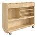 A Flash Furniture wooden mobile storage cart with shelves and cubbies on wheels.