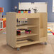 A Flash Furniture wooden mobile storage cart with paint bottles and paints on it.