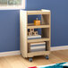 A Flash Furniture wooden mobile storage cart with toys on shelves.