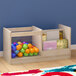 A Flash Furniture wooden double-sided book display stand with clear storage bin on a wooden shelf with colorful balls and cards.