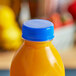 A bottle of orange juice with a Royal Blue Tamper-Evident Cap.