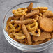 A bowl of Albanese Frank's RedHot Buffalo Snack Mix with pretzels and crackers.