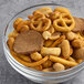 A bowl of Albanese Cajun Kicker Snack Mix with pretzels and peanuts.