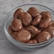 A bowl of Albanese milk chocolate covered pecans.