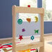 A wooden Flash Furniture double-sided easel with a window and storage tray.