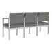 A row of Lesro Lenox steel and fabric 3-seat sofas with center arms in grey and white fabric.
