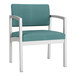 A blue Lesro Lenox oversized guest chair with metal legs and arms and white vinyl accents.