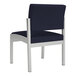 A navy blue Lesro Lenox guest chair with white legs.