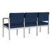 A row of Lesro Lenox steel chairs with navy blue vinyl seats.
