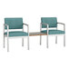 Two blue Lesro Lenox chairs with a table.