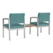Two Lesro Lenox steel armchairs with blue upholstered seats and a metal table connecting them.