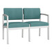 A Lesro Lenox loveseat with teal vinyl and white metal frame.