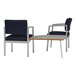 Two Lesro Lenox steel arm chairs with blue cushions next to a Sarum Twill laminate corner table.