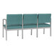 A row of Lesro Lenox steel chairs with blue cushions.