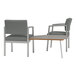 Two grey Lesro Lenox arm chairs next to a table with a Sarum Twill laminate top.