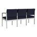 A Lesro Lenox steel chair with navy fabric cushions and white legs.