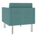 A teal Lesro Luxe Lounge armchair with silver legs.