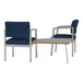 Two Lesro Lenox blue fabric arm chairs with a connecting table.