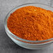A bowl of orange powder, McCormick Culinary Vietnamese Cajun Seasoning.