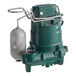 A green and silver Zoeller cast iron water pump.