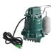 A green and grey Zoeller M63 water pump with a cord attached.