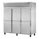 A large silver True Spec Series reach-in refrigerator with white cabinet and silver half doors.