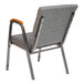 A Flash Furniture gray church chair with wooden armrests.