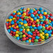A bowl of 4M Rainbow Sugar Shell Cocoa Drops.