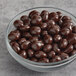 A bowl of dark chocolate covered coffee beans.