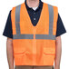 A small Cordova orange high visibility safety vest with reflective stripes.
