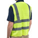 A man wearing a lime green high visibility mesh safety vest.