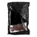 A black bag of Bronco Billy's Old Country Beef Jerky with a white label over a clear plastic bag.