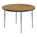 A Correll round activity table with a medium oak wooden top and silver metal legs.