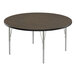 A Correll round activity table with metal legs and a walnut top.