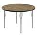 A Correll round activity table with metal legs and a wood surface.