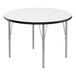 A Correll round white activity table with metal legs and black trim.
