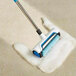 A CRB Cleaning Systems carpet renovator brush with a blue handle and white foam.