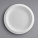 A Dixie white paper plate with a white rim on a gray background.